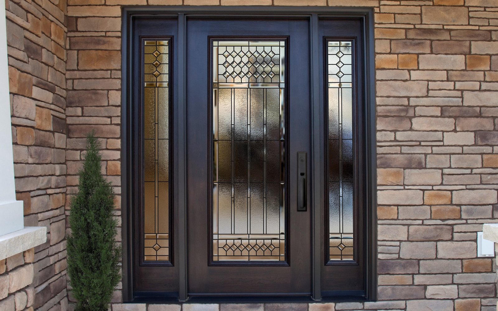 Black double door with sidelights on an exposed brick elevation