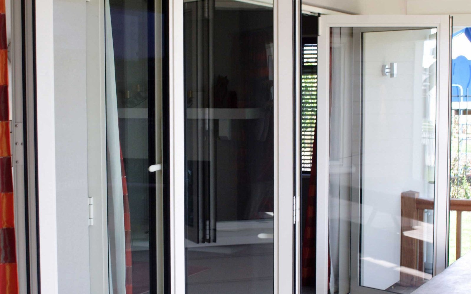 Full-height glazed door opening in a bright modern interior