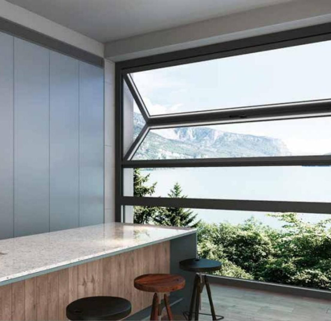 Aluminium casement window with the sash open onto a lake view
