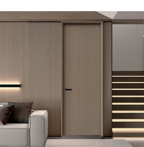 Tall dark-framed full-glass pivot door in a bright minimalist interior