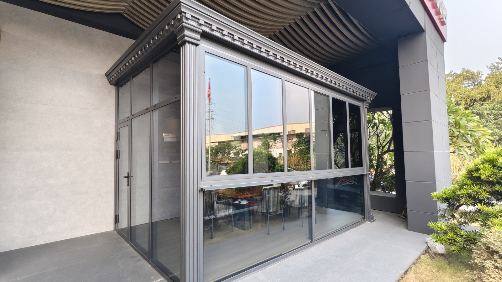 A black-framed glazed pergola and terrace enclosure built on site