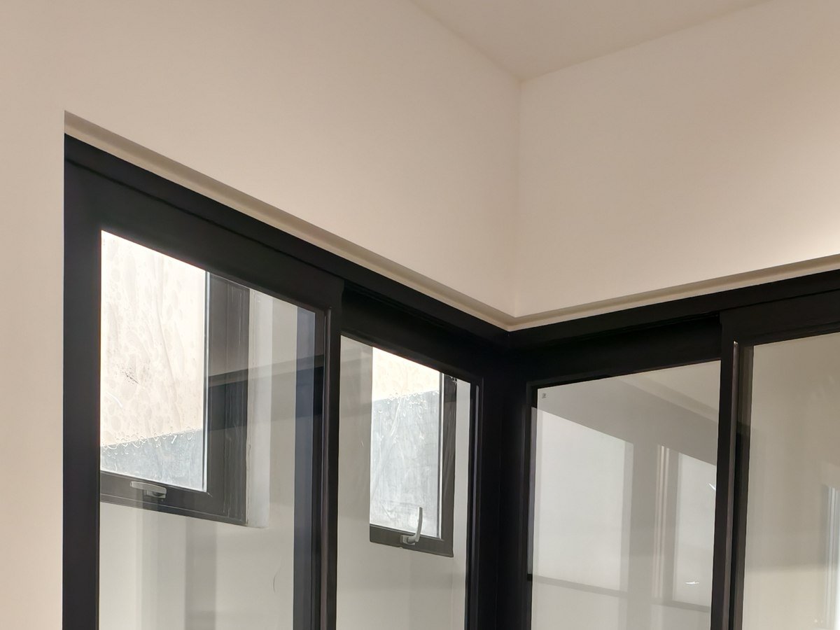 Floor-to-ceiling fixed glazing meeting at a corner post
