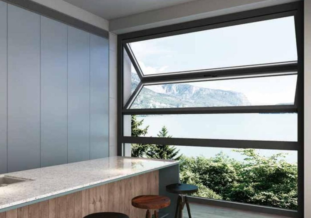 Aluminium casement window with the sash open onto a lake view