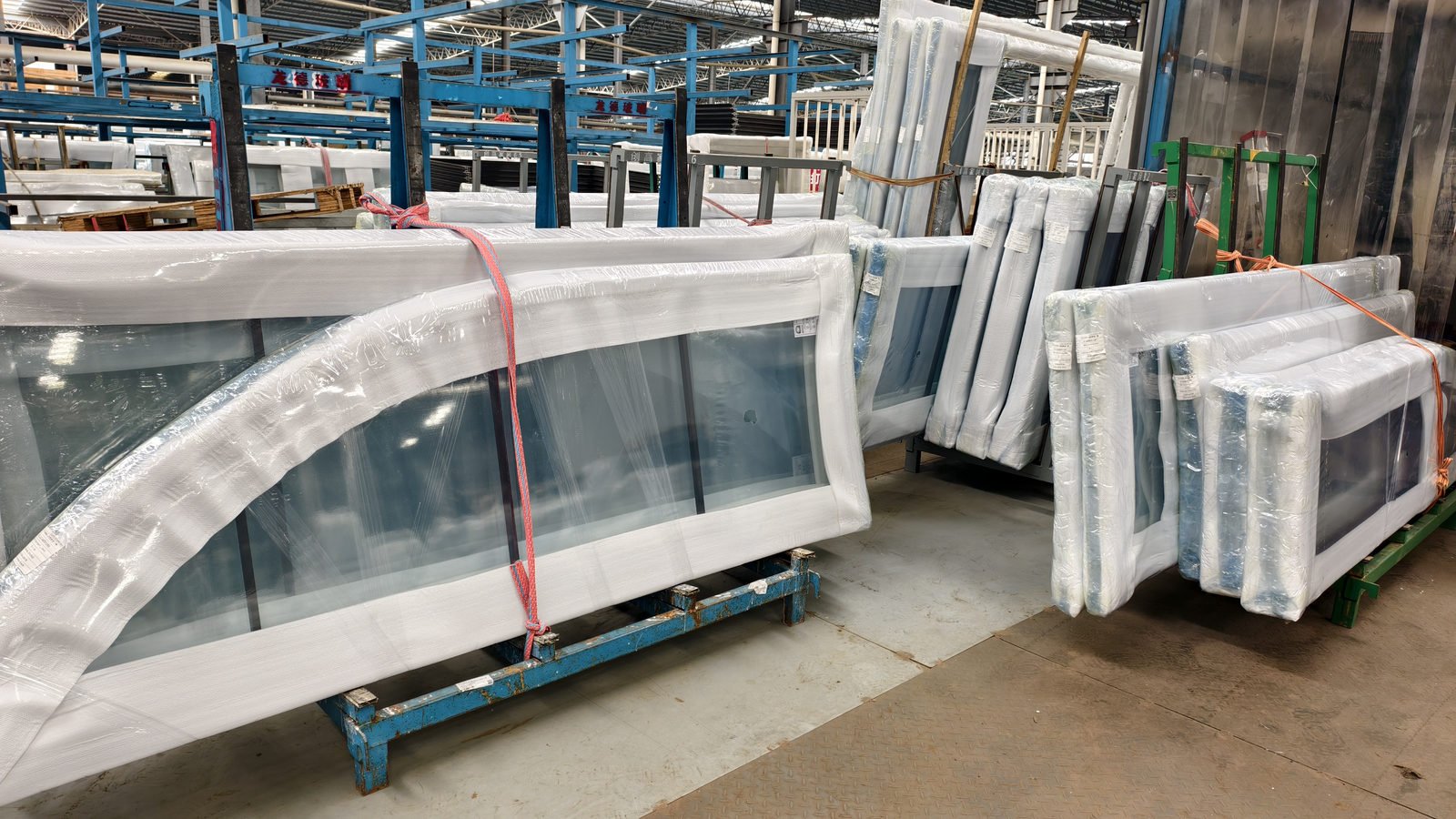 White finished window frames wrapped with foam corner protectors in the packing area