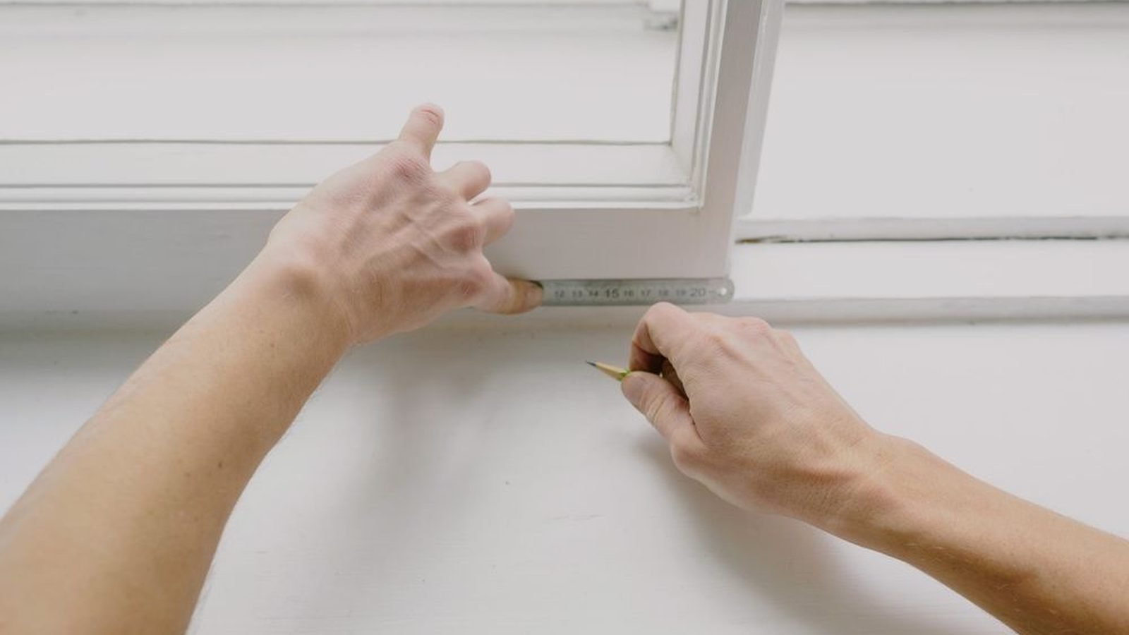 A window frame measured with a rule before it goes into the opening