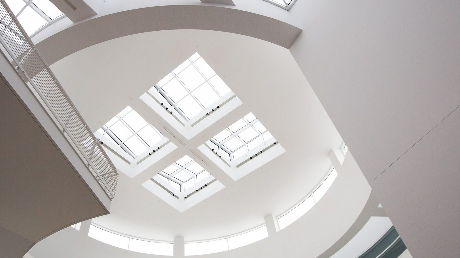 Four flat skylights set into a white ceiling, the shaft splayed out to the room below