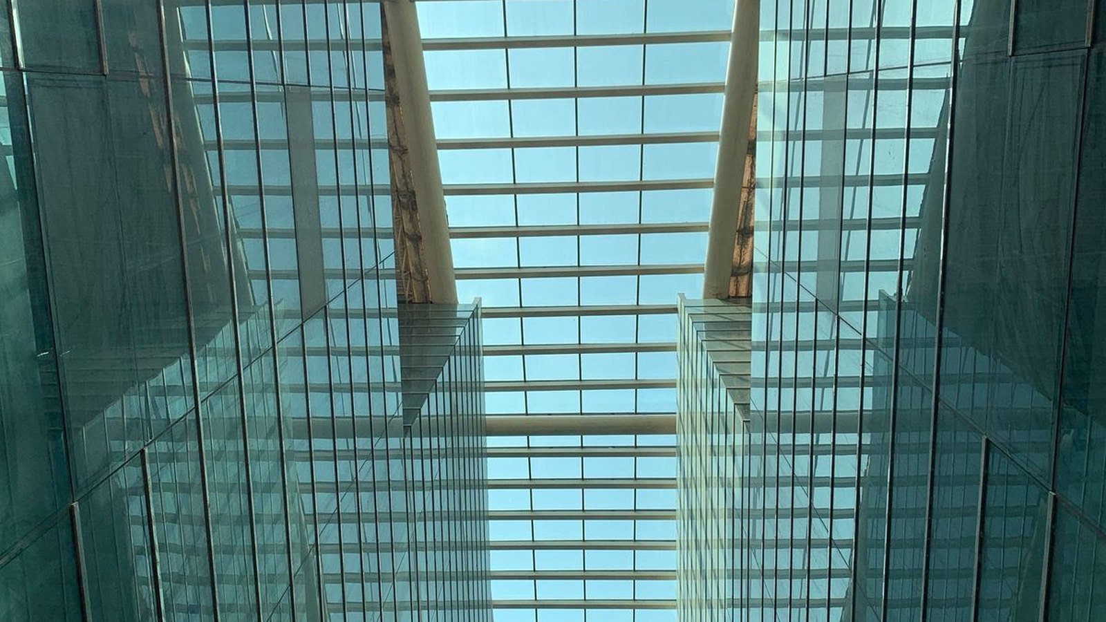 A site-built overhead glazing roof over an atrium, the framing and glass assembled on site