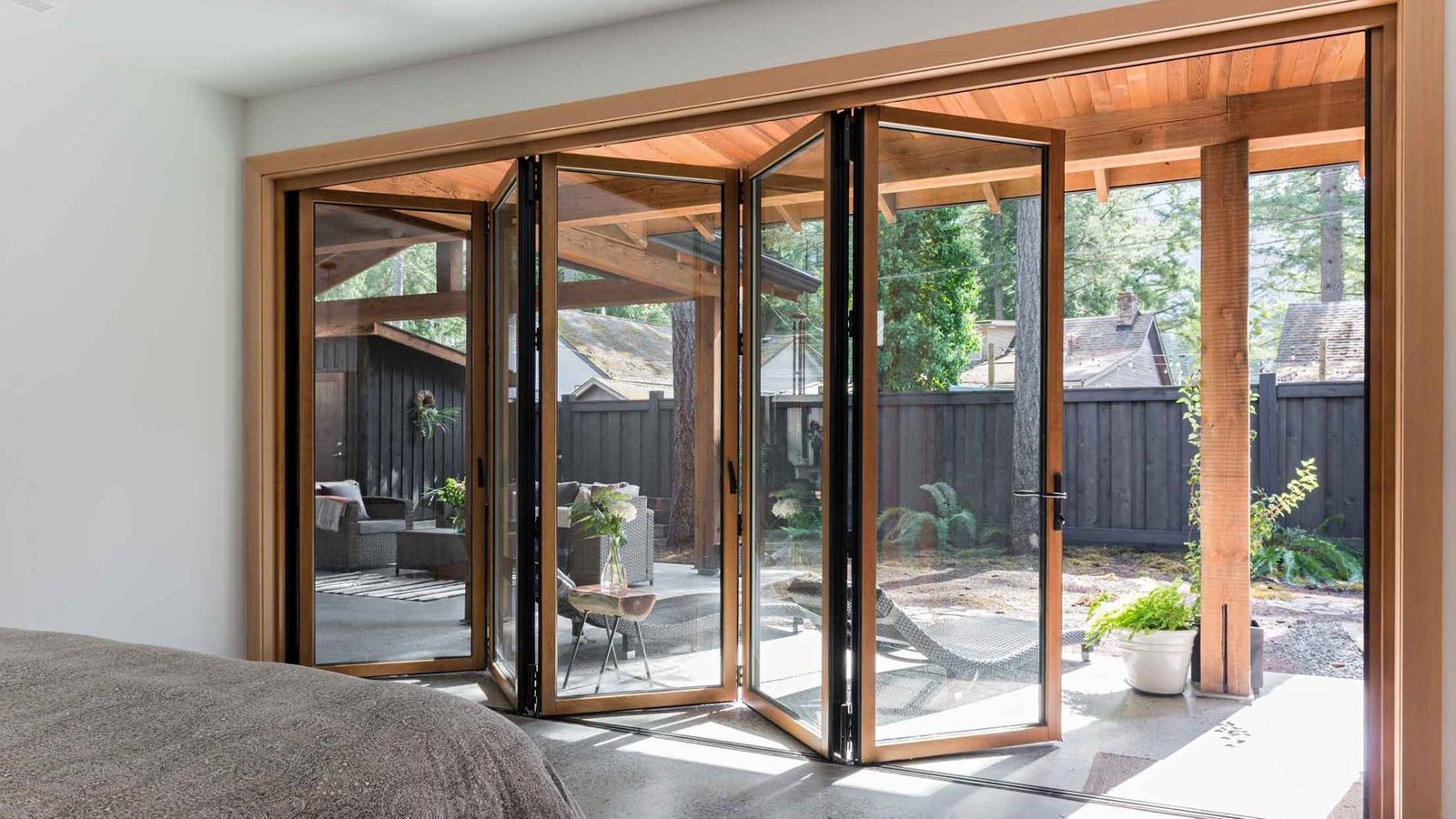 Timber bifold glass wall open onto a garden verandah