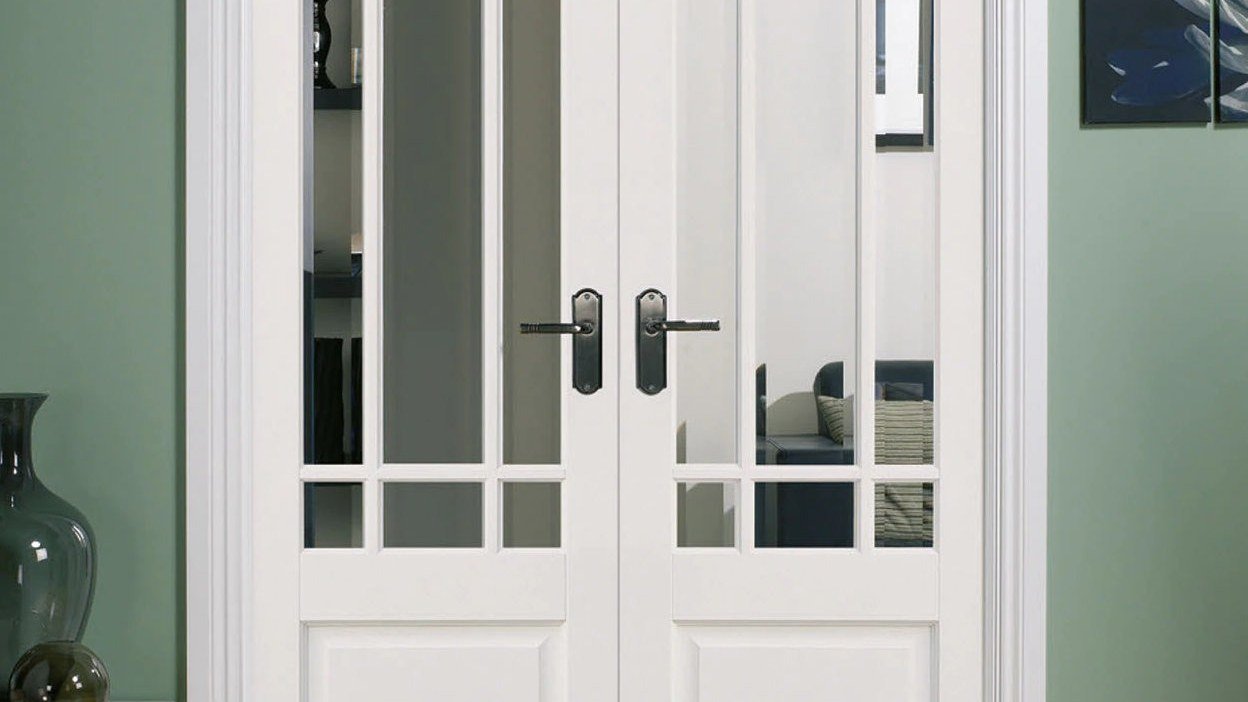 White French glazed doors in a bright paneled interior