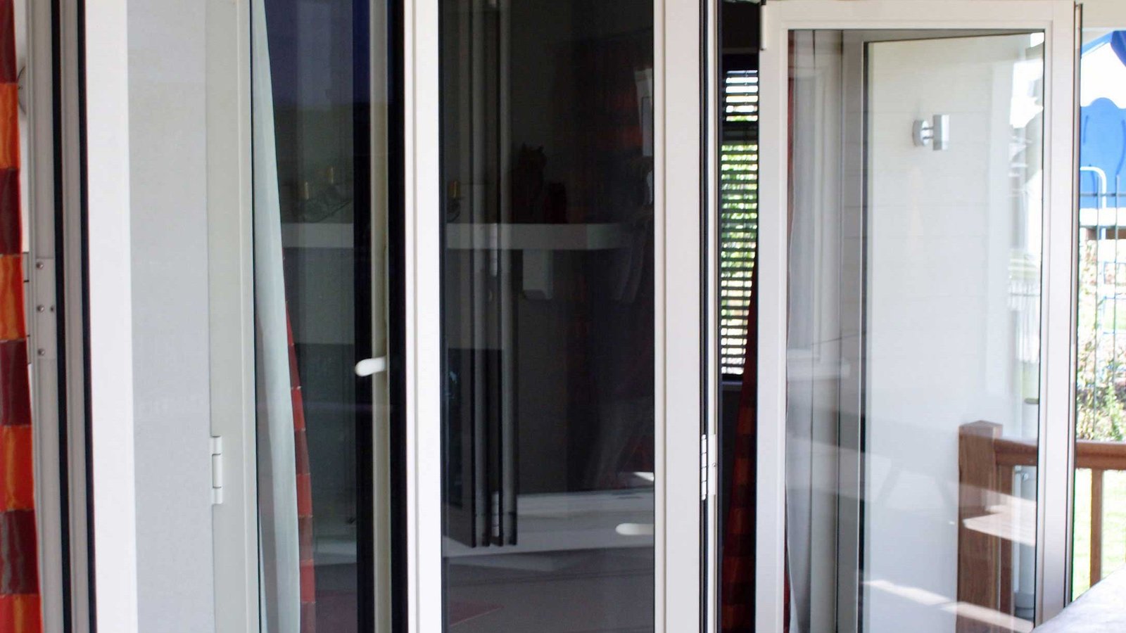 Open white-framed glazed unit in a sunlit interior