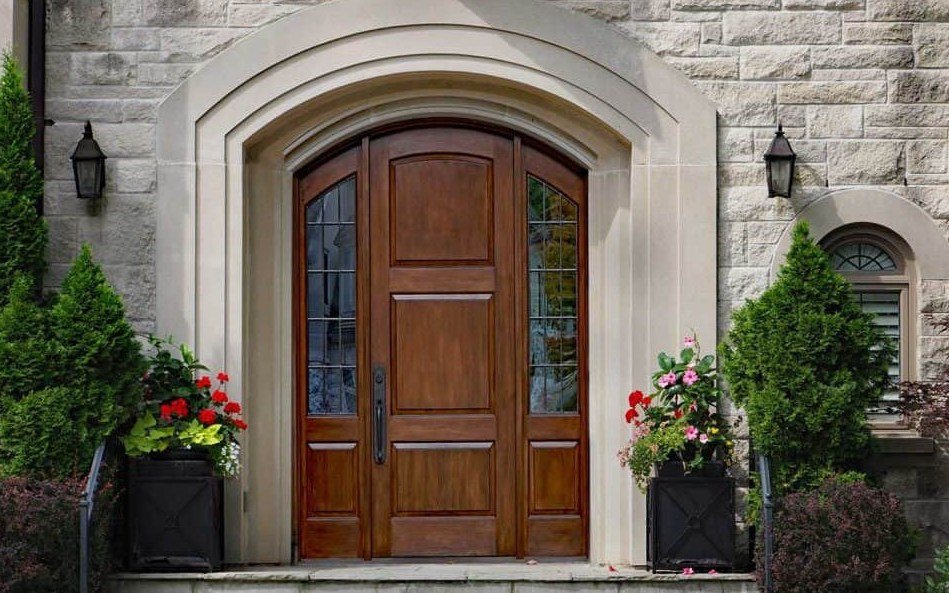 Dark glazed door set on a white residential facade