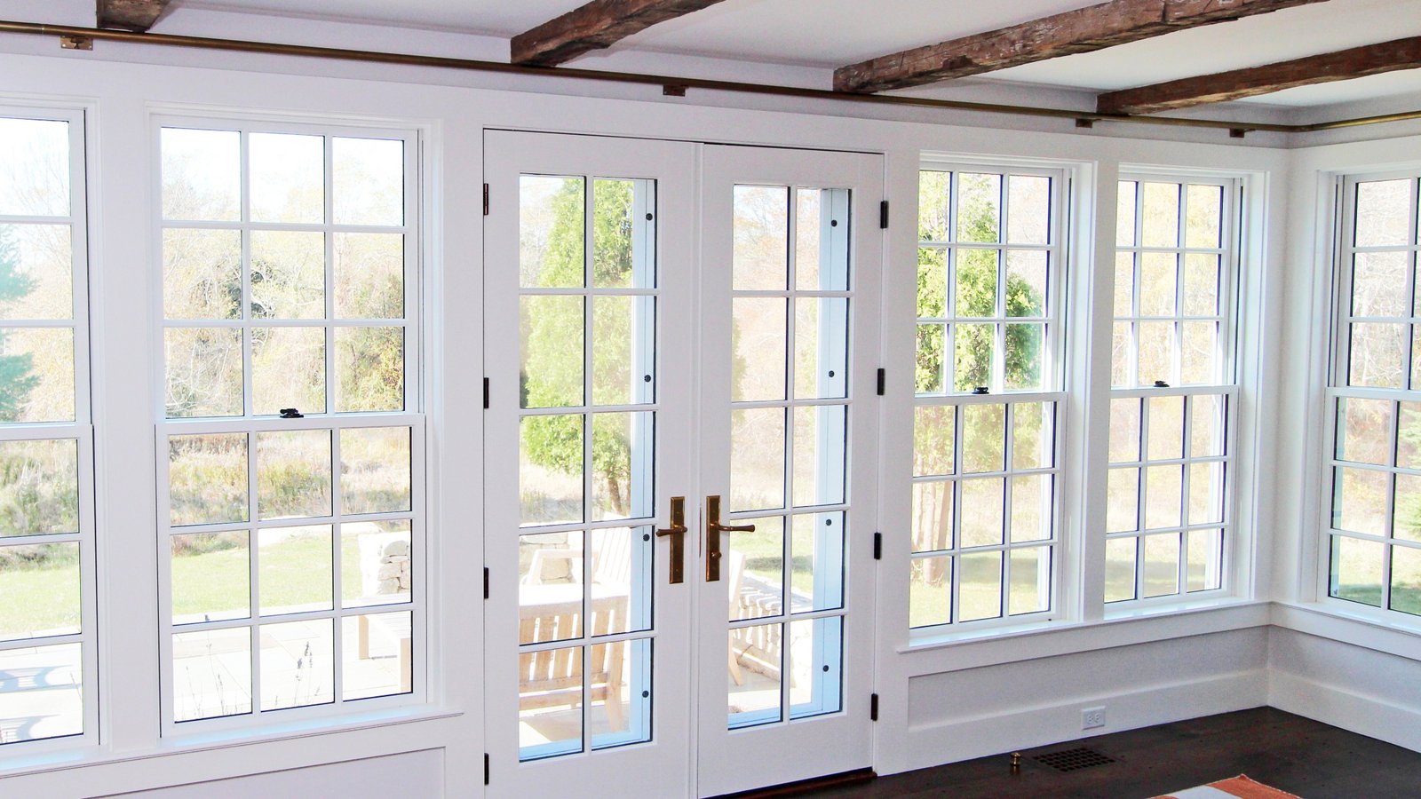 Glass doors and sidelights on a storm-zone residential elevation