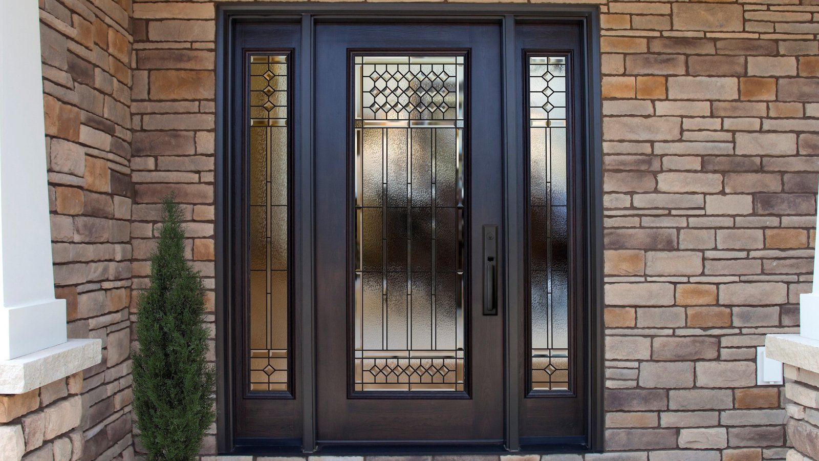 Black double door with sidelights on a stone entrance