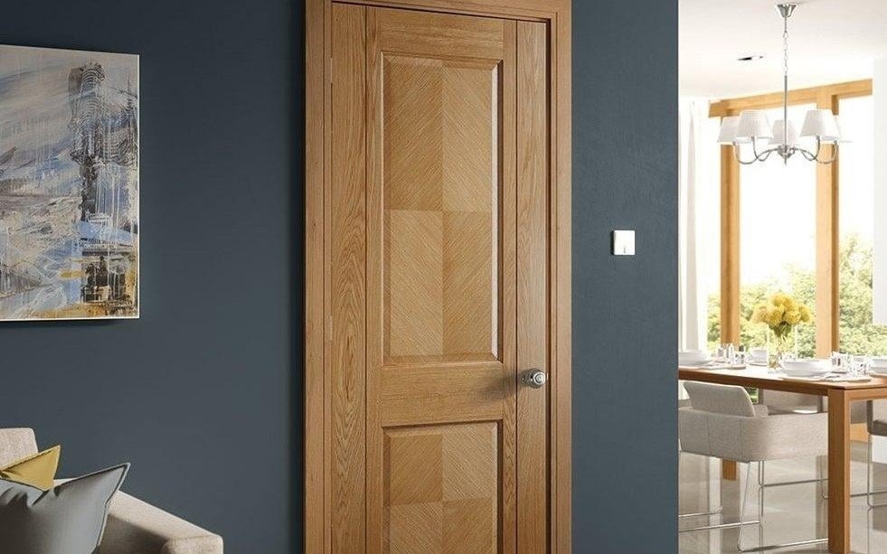 Oak glazed door with handle in a dark modern interior
