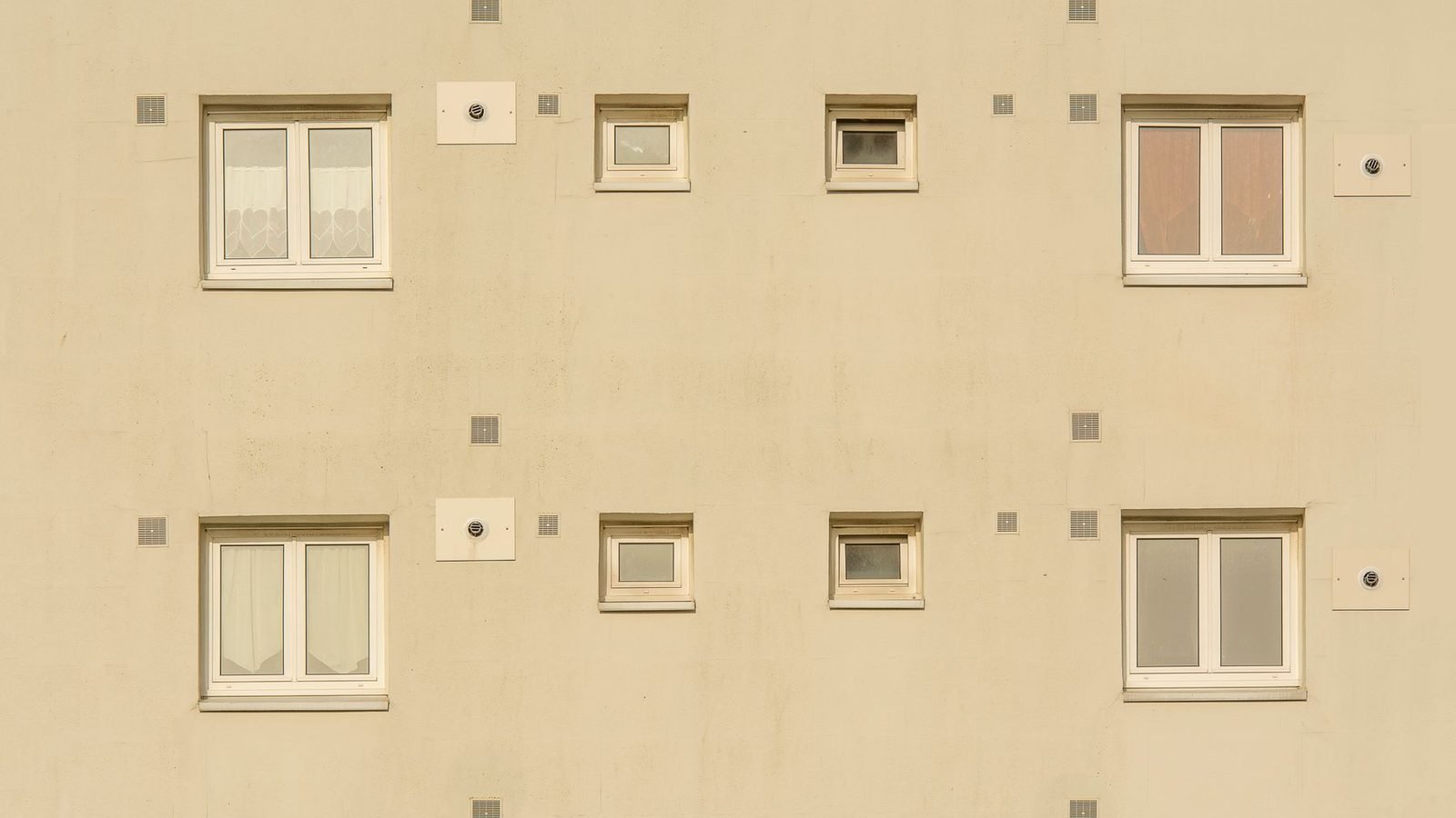 A rendered facade with four different window types set into the wall